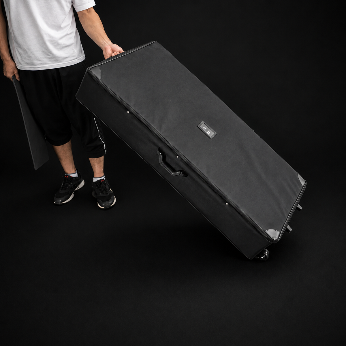 Padded rolling travel case with wheels, zippered top and carry handles